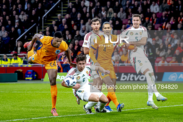 Netherlands defender Denzel Dumfries, Hungary midfielder Tamas Nikitscher, and Netherlands defender Virgil van Dijk participate in the match...