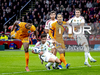 Netherlands defender Denzel Dumfries, Hungary midfielder Tamas Nikitscher, and Netherlands defender Virgil van Dijk participate in the match...