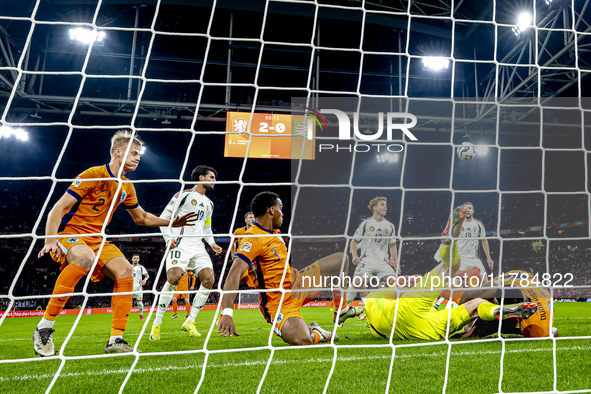 Netherlands defender Denzel Dumfries, Hungary midfielder Tamas Nikitscher, and Netherlands defender Virgil van Dijk participate in the match...