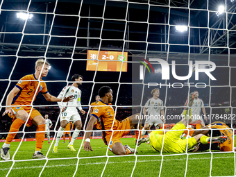 Netherlands defender Denzel Dumfries, Hungary midfielder Tamas Nikitscher, and Netherlands defender Virgil van Dijk participate in the match...