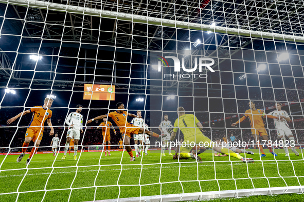 Netherlands defender Denzel Dumfries, Hungary midfielder Tamas Nikitscher, and Netherlands defender Virgil van Dijk participate in the match...