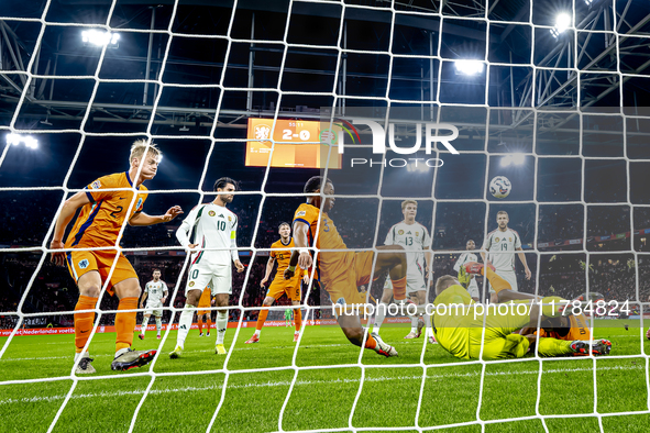 Netherlands defender Denzel Dumfries, Hungary midfielder Tamas Nikitscher, and Netherlands defender Virgil van Dijk participate in the match...