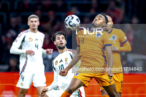 Hungary midfielder Dominik Szoboslai and Netherlands midfielder Ryan Gravenberch play during the match between the Netherlands and Hungary a...