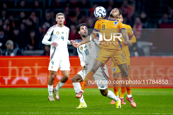 Hungary midfielder Dominik Szoboslai and Netherlands midfielder Ryan Gravenberch play during the match between the Netherlands and Hungary a...