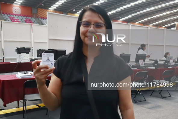 A person shows his new permanent driver's license after applying for it at the processing point installed in the Ciudad Deportiva, in the Iz...