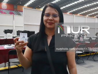 A person shows his new permanent driver's license after applying for it at the processing point installed in the Ciudad Deportiva, in the Iz...