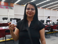 A person shows his new permanent driver's license after applying for it at the processing point installed in the Ciudad Deportiva, in the Iz...