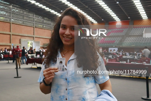 A person shows his new permanent driver's license after applying for it at the processing point installed in the Ciudad Deportiva, in the Iz...