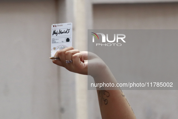 A person shows his new permanent driver's license after applying for it at the processing point installed in the Ciudad Deportiva, in the Iz...