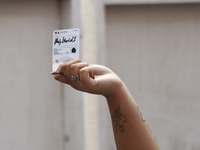 A person shows his new permanent driver's license after applying for it at the processing point installed in the Ciudad Deportiva, in the Iz...