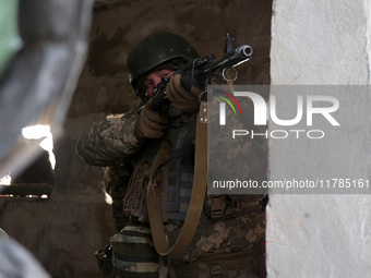 One of the new soldiers of the 57th Otaman Kost Hordiienko Motorized Brigade practices assault skills in the Kharkiv region, Ukraine, on Nov...