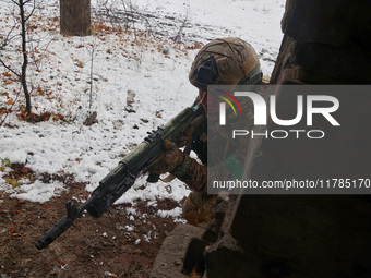 One of the new soldiers of the 57th Otaman Kost Hordiienko Motorized Brigade practices assault skills in the Kharkiv region, Ukraine, on Nov...