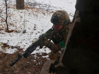 One of the new soldiers of the 57th Otaman Kost Hordiienko Motorized Brigade practices assault skills in the Kharkiv region, Ukraine, on Nov...