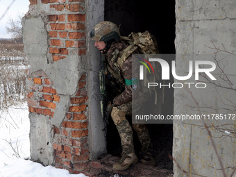 One of the new soldiers of the 57th Otaman Kost Hordiienko Motorized Brigade practices assault skills in the Kharkiv region, Ukraine, on Nov...