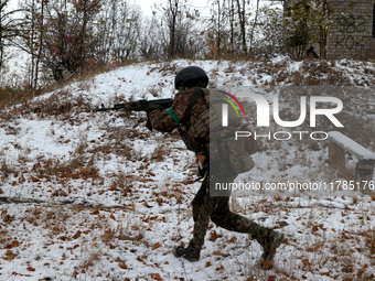 One of the new soldiers of the 57th Otaman Kost Hordiienko Motorized Brigade practices assault skills in the Kharkiv region, Ukraine, on Nov...