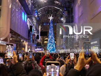 A large crowd gathers to witness the annual Christmas tree lighting ceremony at CF Toronto Eaton Centre in Ontario, Canada, on November 13,...