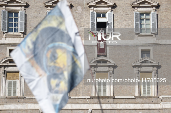 Pope Francis addresses the crowd from the window of the apostolic palace overlooking St. Peter's Square during the Angelus prayer in The Vat...