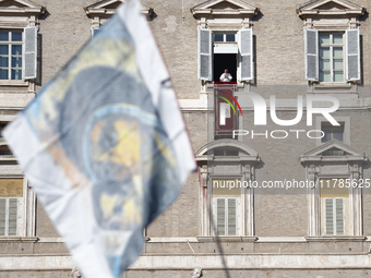 Pope Francis addresses the crowd from the window of the apostolic palace overlooking St. Peter's Square during the Angelus prayer in The Vat...