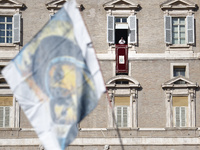 Pope Francis addresses the crowd from the window of the apostolic palace overlooking St. Peter's Square during the Angelus prayer in The Vat...