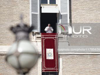 Pope Francis addresses the crowd from the window of the apostolic palace overlooking St. Peter's Square during the Angelus prayer in The Vat...