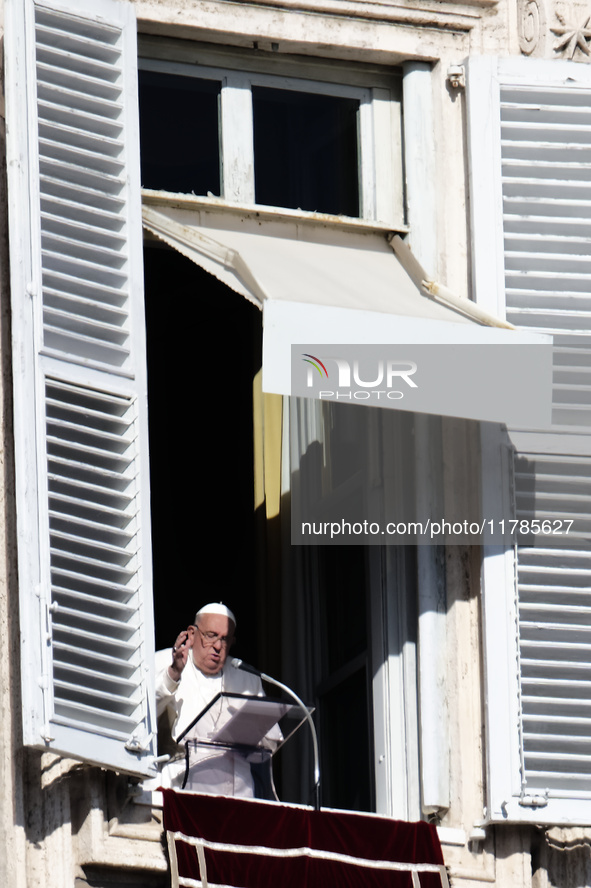 Pope Francis addresses the crowd from the window of the apostolic palace overlooking St. Peter's Square during the Angelus prayer in The Vat...