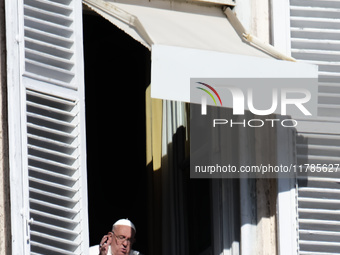 Pope Francis addresses the crowd from the window of the apostolic palace overlooking St. Peter's Square during the Angelus prayer in The Vat...