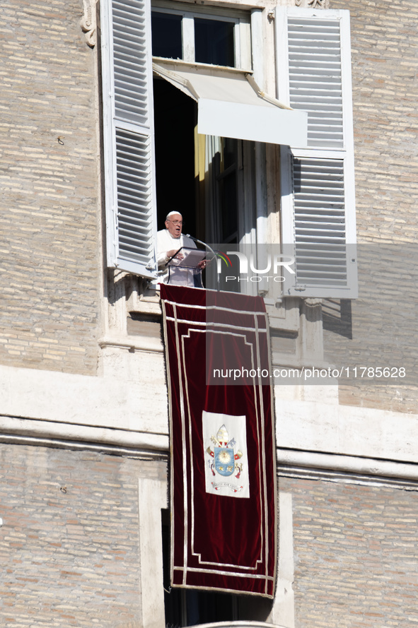 Pope Francis addresses the crowd from the window of the apostolic palace overlooking St. Peter's Square during the Angelus prayer in The Vat...