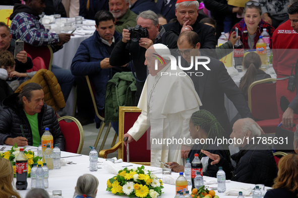 Pope Francis sits to share a lunch with people on the World Day of the Poor at the Paul VI audience hall in The Vatican, on November 17, 202...