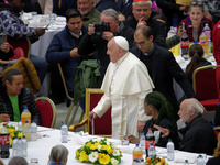 Pope Francis sits to share a lunch with people on the World Day of the Poor at the Paul VI audience hall in The Vatican, on November 17, 202...