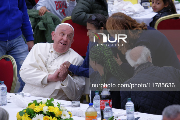 Pope Francis sits to share a lunch with people on the World Day of the Poor at the Paul VI audience hall in The Vatican, on November 17, 202...