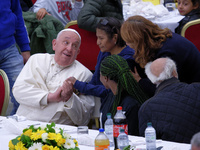 Pope Francis sits to share a lunch with people on the World Day of the Poor at the Paul VI audience hall in The Vatican, on November 17, 202...