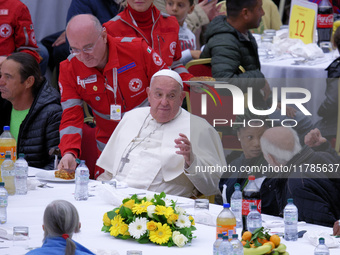 Pope Francis sits to share a lunch with people on the World Day of the Poor at the Paul VI audience hall in The Vatican, on November 17, 202...