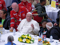 Pope Francis sits to share a lunch with people on the World Day of the Poor at the Paul VI audience hall in The Vatican, on November 17, 202...