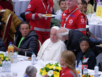 Pope Francis sits to share a lunch with people on the World Day of the Poor at the Paul VI audience hall in The Vatican, on November 17, 202...