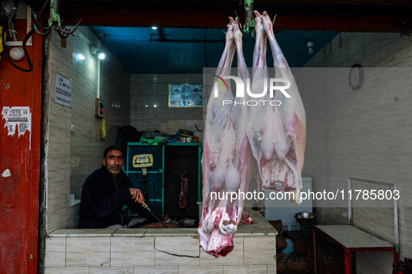 A butcher who sells mutton waits for customers in Sopore, Jammu and Kashmir, India, on November 17, 2024. 