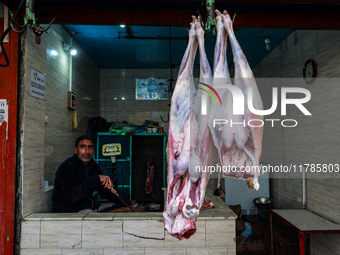 A butcher who sells mutton waits for customers in Sopore, Jammu and Kashmir, India, on November 17, 2024. (