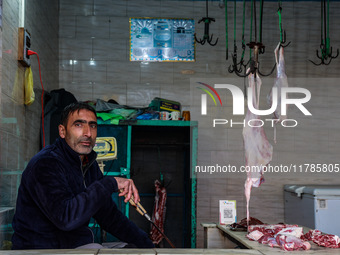 A butcher who sells mutton waits for customers in Sopore, Jammu and Kashmir, India, on November 17, 2024. (