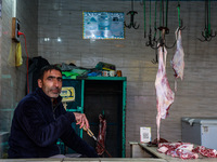 A butcher who sells mutton waits for customers in Sopore, Jammu and Kashmir, India, on November 17, 2024. (