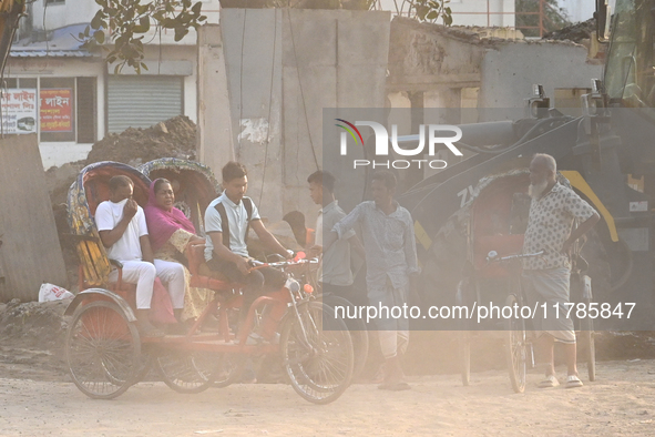 People navigate a dusty road in Dhaka, Bangladesh, on November 17, 2024. The city has ranked first on the list of cities with the worst air...