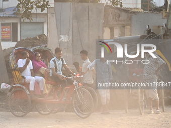 People navigate a dusty road in Dhaka, Bangladesh, on November 17, 2024. The city has ranked first on the list of cities with the worst air...