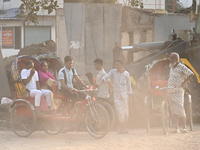 People navigate a dusty road in Dhaka, Bangladesh, on November 17, 2024. The city has ranked first on the list of cities with the worst air...