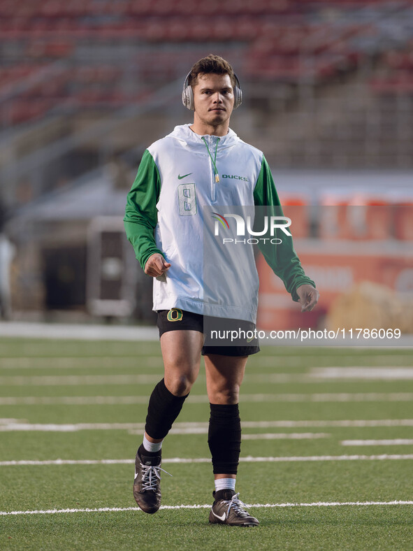 Oregon quarterback Dillon Gabriel #8 warms up at Camp Randall Stadium against the Wisconsin Badgers in Madison, Wisconsin, on November 16, 2...