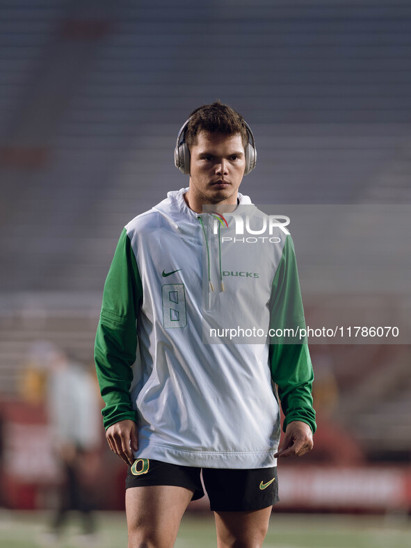 Oregon quarterback Dillon Gabriel #8 warms up at Camp Randall Stadium against the Wisconsin Badgers in Madison, Wisconsin, on November 16, 2...