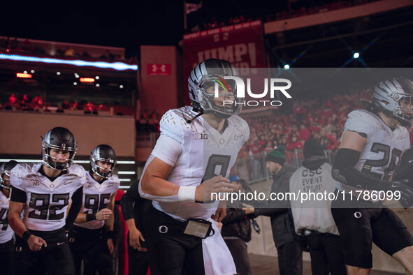 Oregon quarterback Dillon Gabriel #8 leads the Oregon Ducks out of the tunnel at Camp Randall Stadium in Madison, Wisconsin, on November 16,...