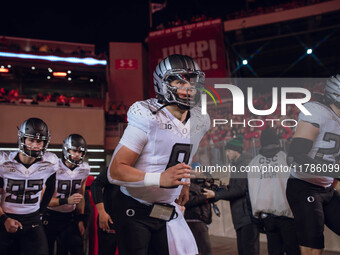 Oregon quarterback Dillon Gabriel #8 leads the Oregon Ducks out of the tunnel at Camp Randall Stadium in Madison, Wisconsin, on November 16,...