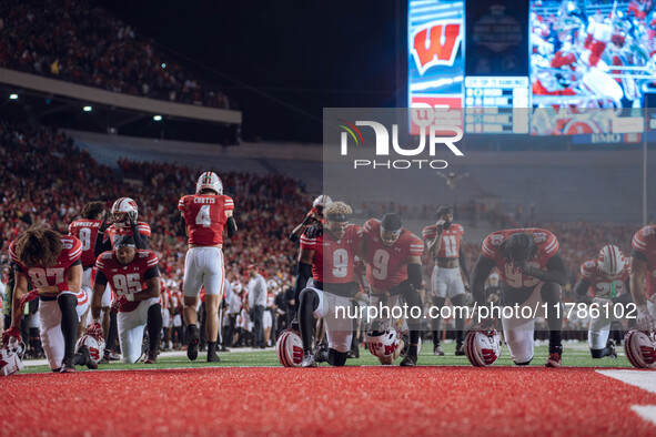 Wisconsin Badgers safety Austin Brown #9 and Wisconsin Badgers wide receiver Bryson Green #9 take a knee prior to kickoff in Madison, Wiscon...