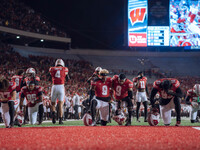 Wisconsin Badgers safety Austin Brown #9 and Wisconsin Badgers wide receiver Bryson Green #9 take a knee prior to kickoff in Madison, Wiscon...