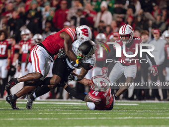 Oregon running back Jordan James #20 is taken down by Wisconsin Badgers outside linebacker Leon Lowery Jr. #8 and Wisconsin Badgers safety P...