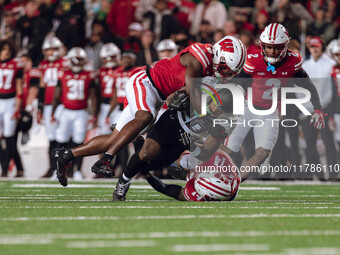 Oregon running back Jordan James #20 is taken down by Wisconsin Badgers outside linebacker Leon Lowery Jr. #8 and Wisconsin Badgers safety P...