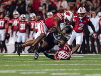 Oregon running back Jordan James #20 is taken down by Wisconsin Badgers outside linebacker Leon Lowery Jr. #8 and Wisconsin Badgers safety P...